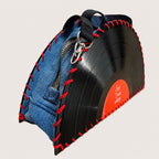 A denim and vinyl record themed zipper pouch with red stitching details, shown on a light beige background.
