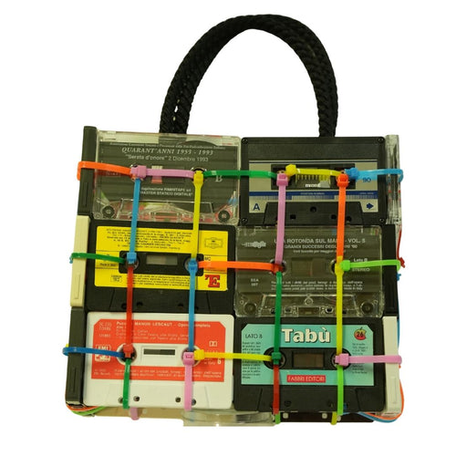 Handbag made from recycled cassette tapes with colorful straps on a white background
