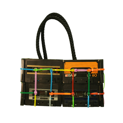 Vintage cassette tape handbag with colorful straps on a white background