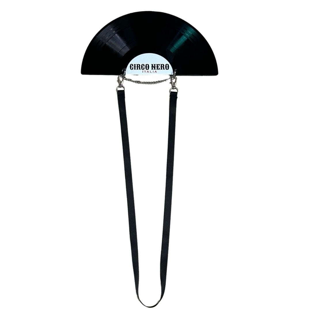 Black vinyl record shaped like a half-circle with a strap, featuring 'Circo Nero' branding on a white background.