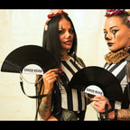 Two women holding black fans with 'Circo Nero' branding against a neutral background.