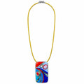 A colorful rectangular glass pendant necklace with an abstract swirl design in red, blue, and white, suspended on a bright yellow cord with a silver clasp, shown against a plain white background. Silvia Tolomei best handmade jewelry in Tuscany. Tuscany jewelry. Tuscan jewelry. Populonia best store to visit. Things to do in populonia. 