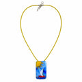 A yellow cord necklace with a rectangular glass pendant featuring a colorful sailboat scene in blue, yellow, white, and red, displayed on a clean white background. Silvia Tolomei best handmade jewelry in Tuscany. Tuscany jewelry. Tuscan jewelry. Populonia best store to visit. Things to do in populonia. 