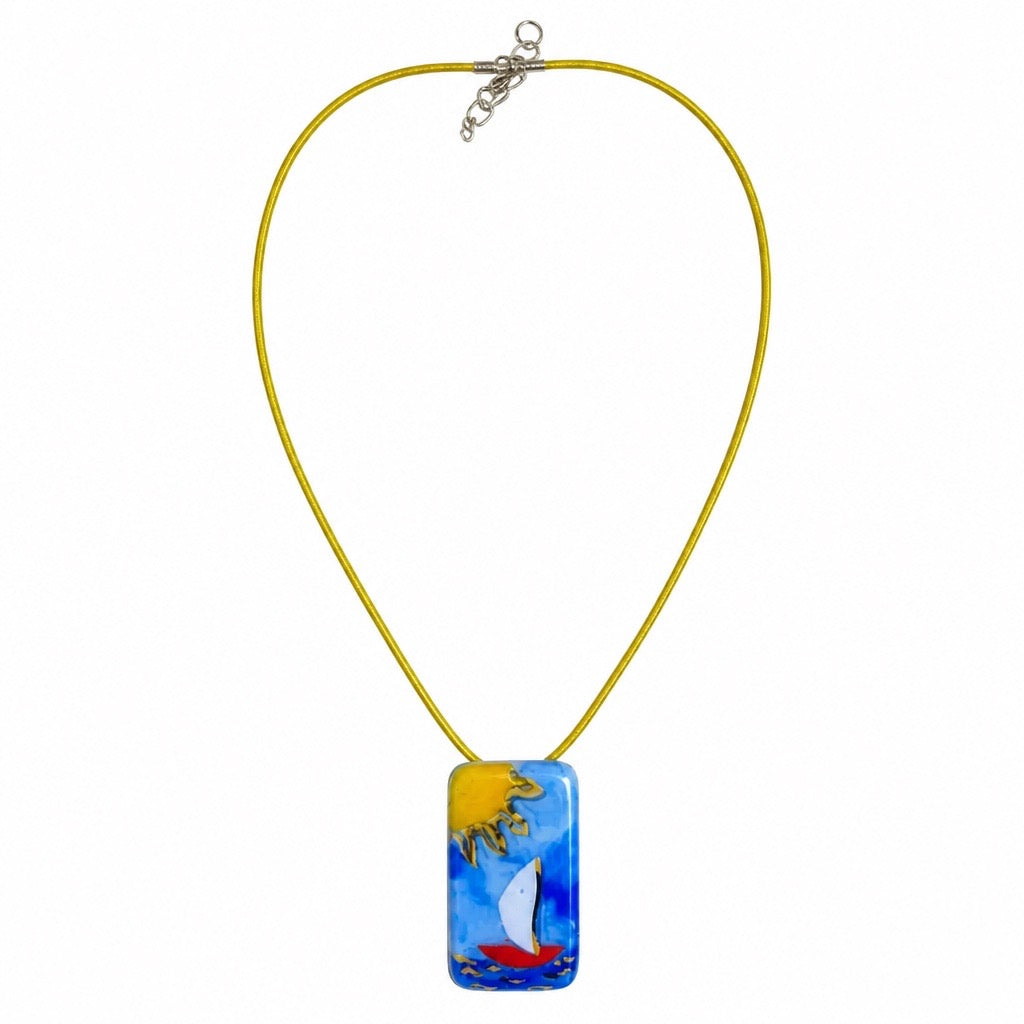 A yellow cord necklace with a rectangular glass pendant featuring a colorful sailboat scene in blue, yellow, white, and red, displayed on a clean white background. Silvia Tolomei best handmade jewelry in Tuscany. Tuscany jewelry. Tuscan jewelry. Populonia best store to visit. Things to do in populonia. 