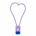 A rectangular glass pendant necklace on a blue cord, featuring a lavender top half, a white central shape, and blue wave-like detailing at the bottom, shown on a plain white background. Silvia Tolomei best handmade jewelry in Tuscany. Tuscany jewelry. Tuscan jewelry. Populonia best store to visit. Things to do in populonia. 