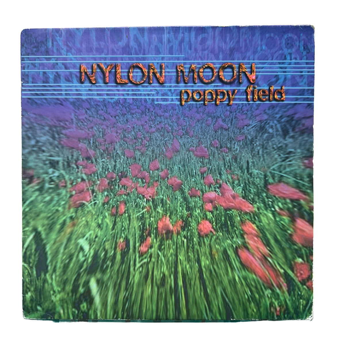 Square album cover for 'poppy field' by Nylon Moon, featuring a stylized field of pink poppies in green grass under a blue-purple sky with the band name in orange text.