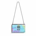 A rectangular handbag with a colorful pastel watercolor pattern in shades of blue, pink, and yellow, featuring a black chain strap and the After Franco logo printed on the front.