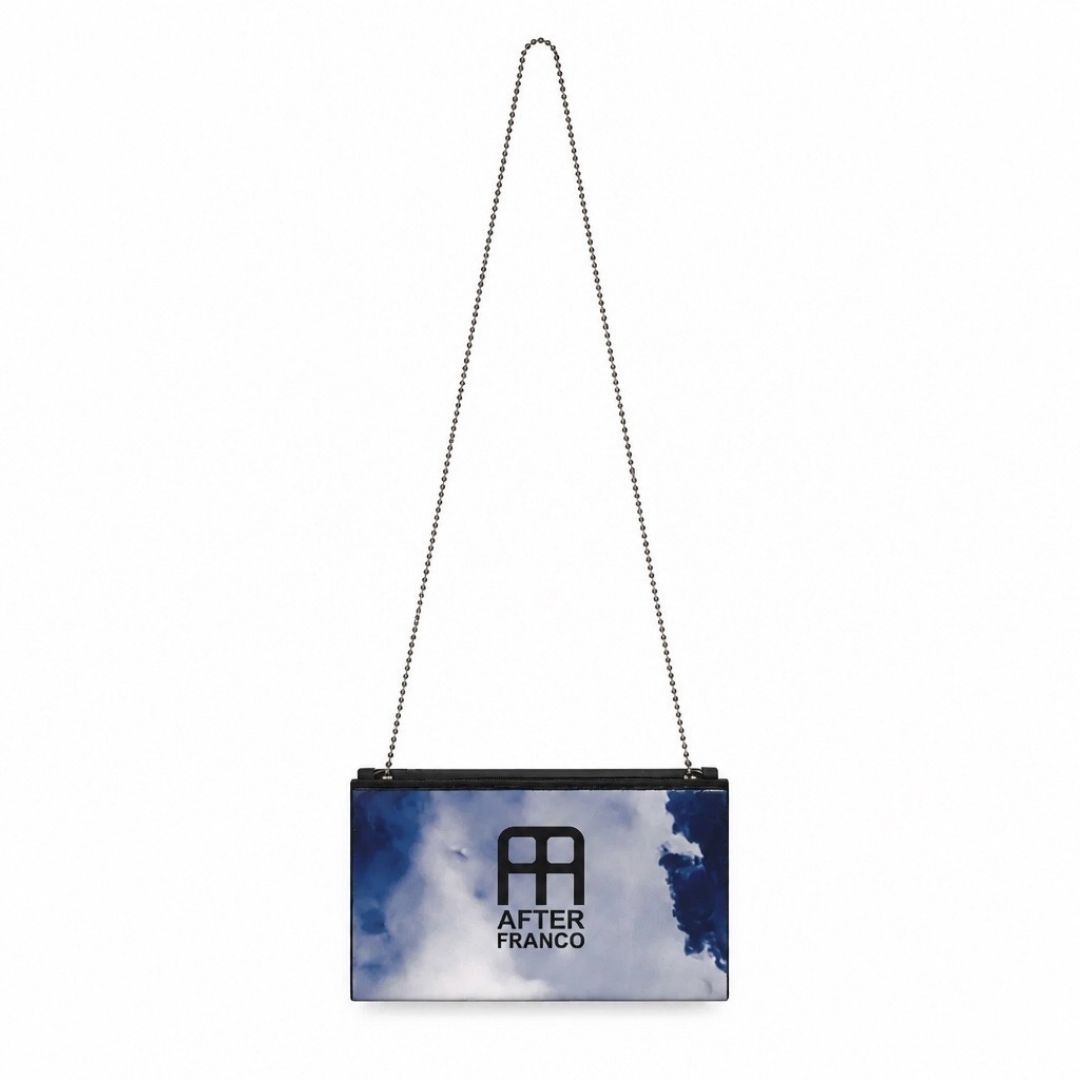 A rectangular shoulder bag with a chain strap, featuring a sky print with blue and white clouds and a black logo that reads 'AFTER FRANCO' on the front, set against a plain white background.