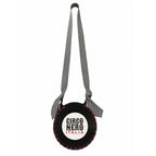 A circular black leather crossbody bag designed like a baseball, featuring red stitching details, a white center with the text 'CIRCO NERO ITALIA' in black and red, and a gray patterned shoulder strap.