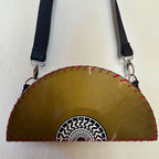 Yellow circular saw blade bag with black strap on a white background. francesca farfa musek label sorry im not a deejay vinyl purse