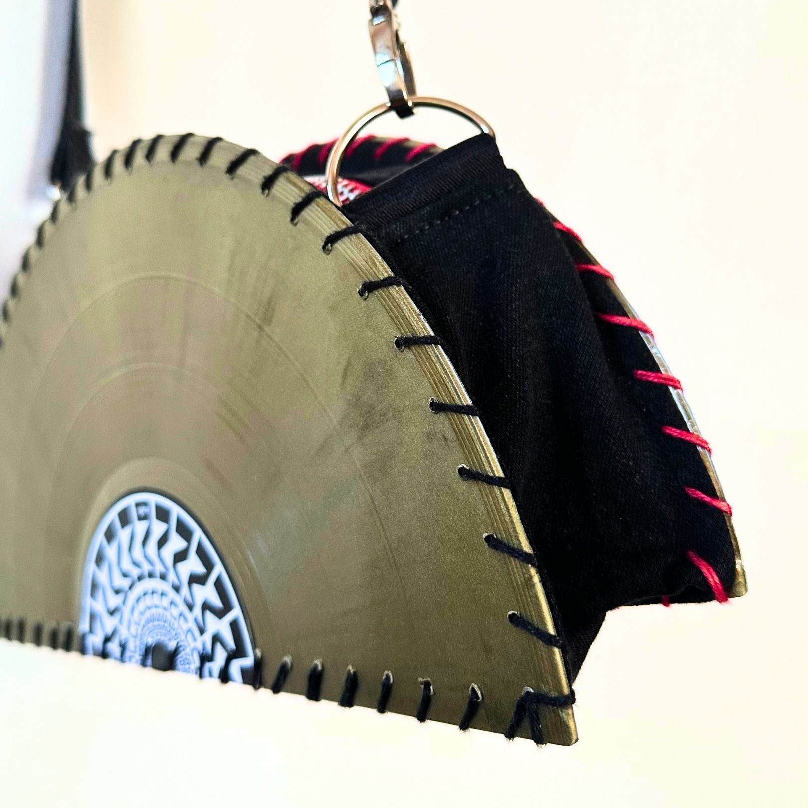 Yellow circular saw blade bag with black strap on a white background. francesca farfa musek label sorry im not a deejay vinyl purse