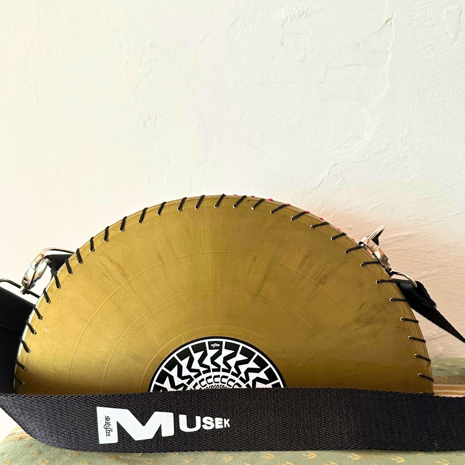 Yellow circular saw blade bag with black strap on a white background. francesca farfa musek label sorry im not a deejay vinyl purse