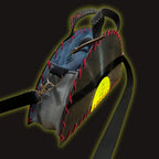 A rugged utility bag with a black corrugated outer shell, red contrast stitching, a blue fabric lining, and a bright yellow circular patch, shown on a dark background with a glowing yellow outline effect.