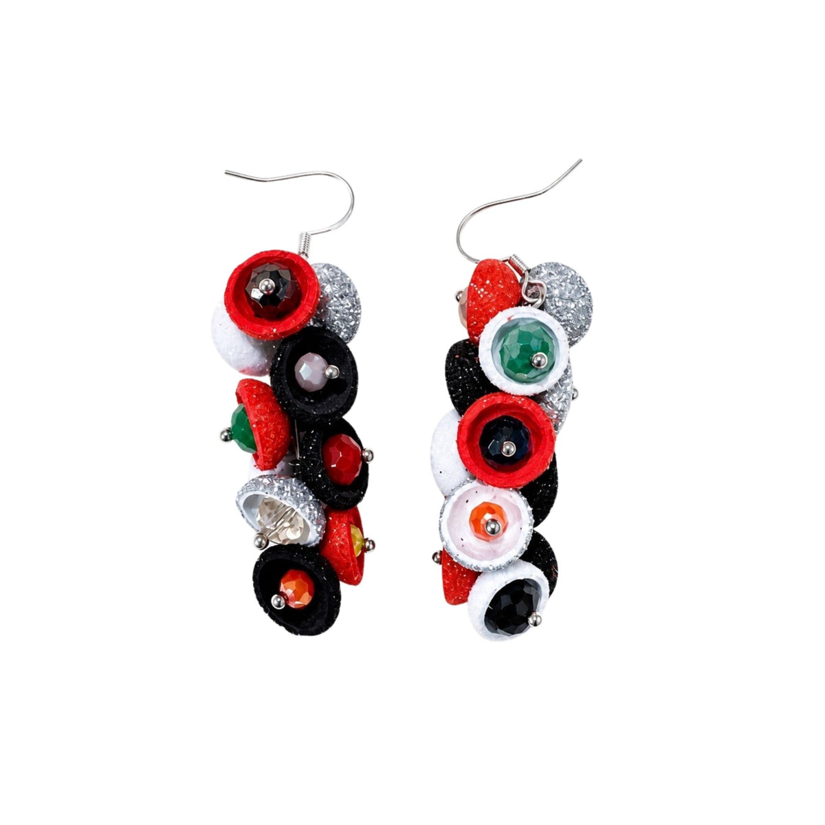 A pair of dangling earrings made from stacked novelty goggle-like pieces in red, black, white, silver glitter, and green, suspended from silver fishhook wires on a plain white background. populonia